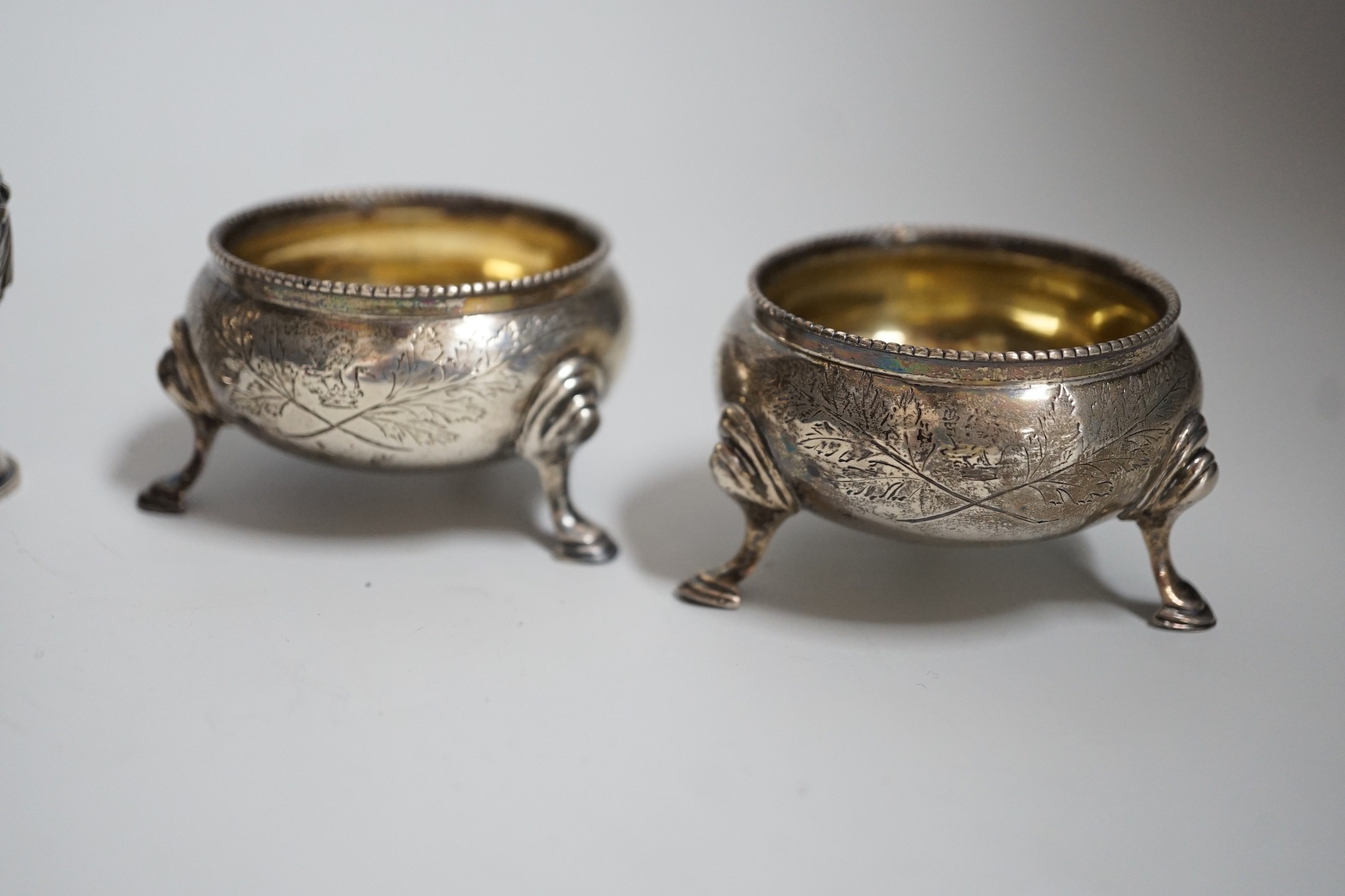 A pair of Victorian silver bun salts, London, 1868, diameter 5cm and a pair of Victorian silver peppers.